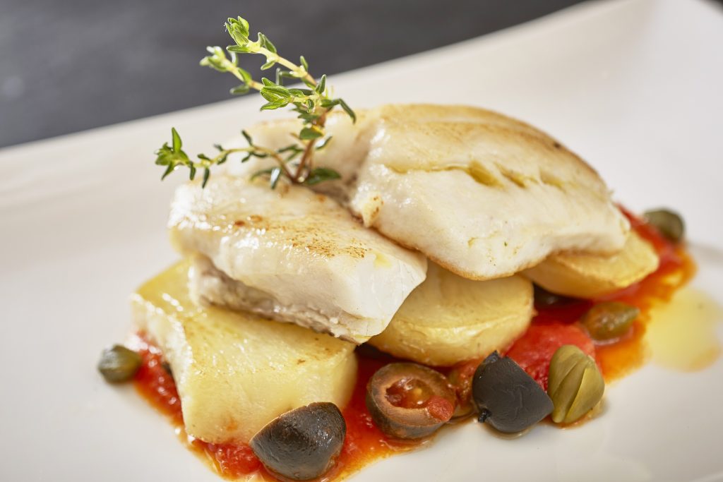 PAN-FRIED SEA BASS FILLET WITH ROASTED POTATOES, CAPERS AND CHERRY-TOMATO SAUCE