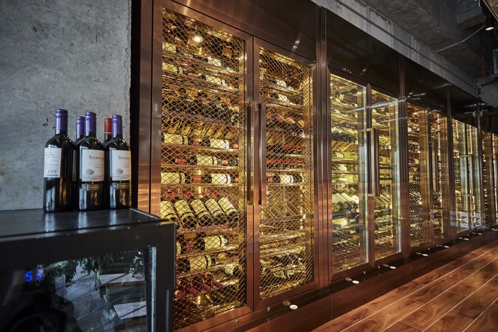 THE SECOND-FLOOR BALCONY BOASTS A STUNNING WINE SELECTION